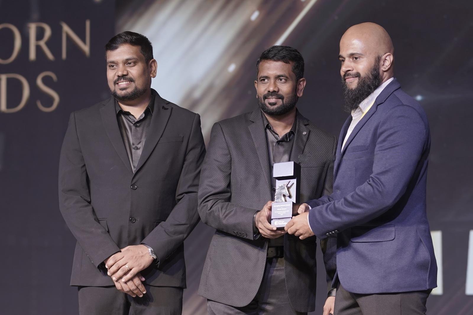Vishak Moopar receiving recognition at an industry event